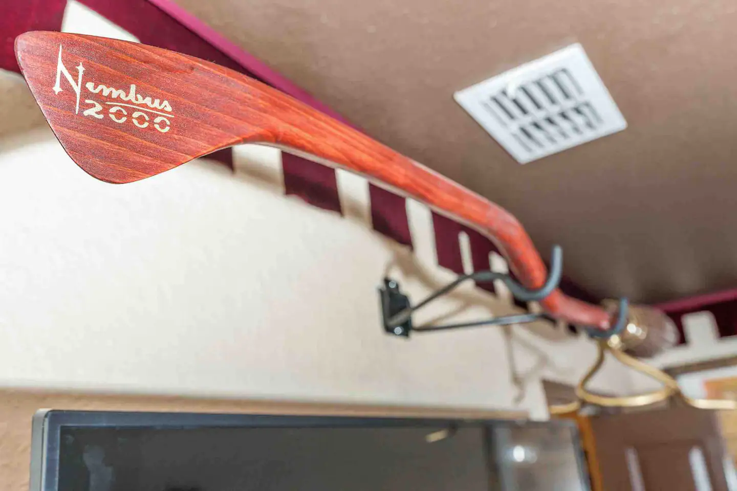 The Nimbus 2000 is located above the Gryffindor bedroom television.