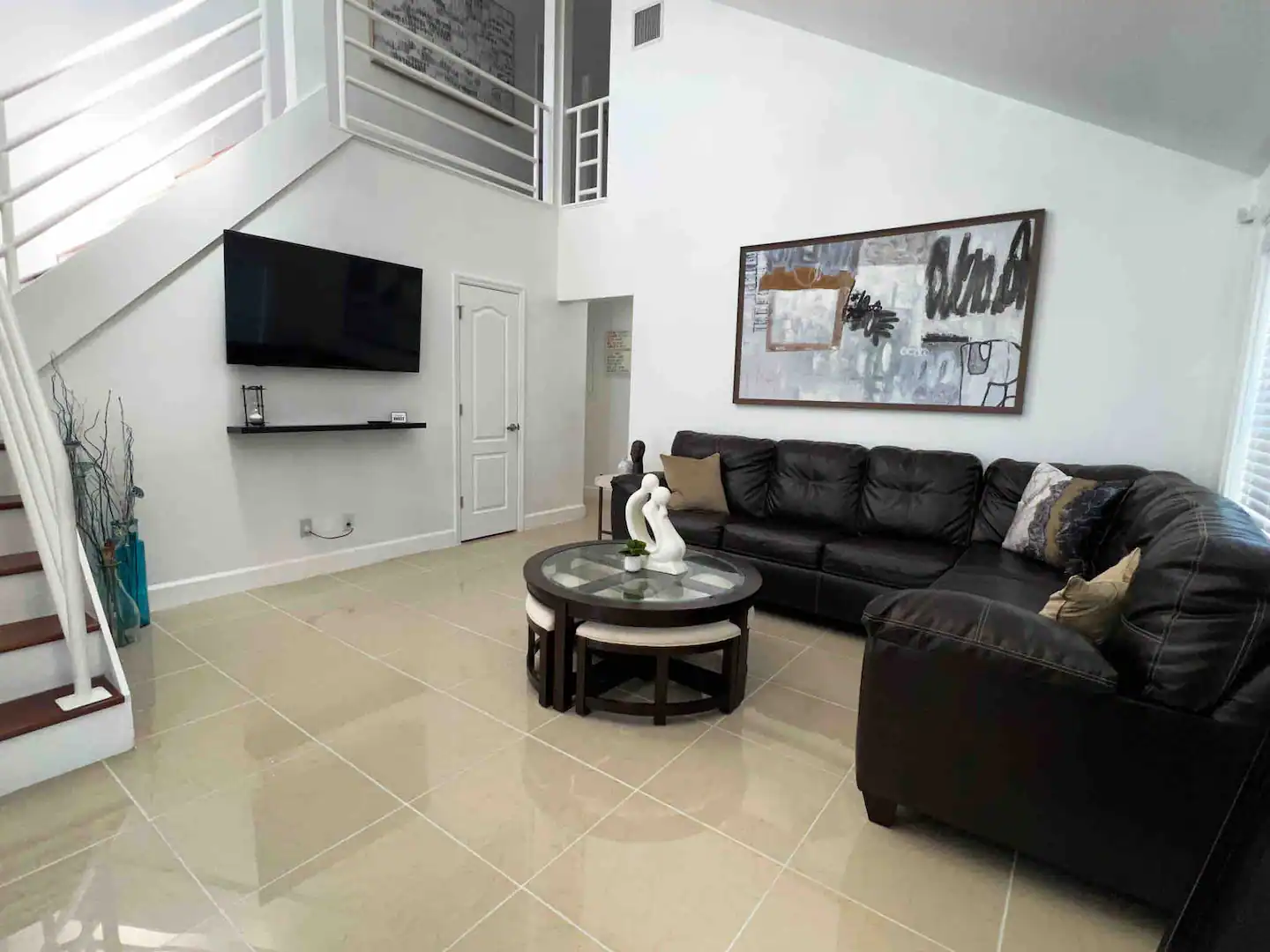 This fun two-story family style home provides a spacious living room with a large sectional seating (also converts into a sofa-bed) for all guest with a large TV.