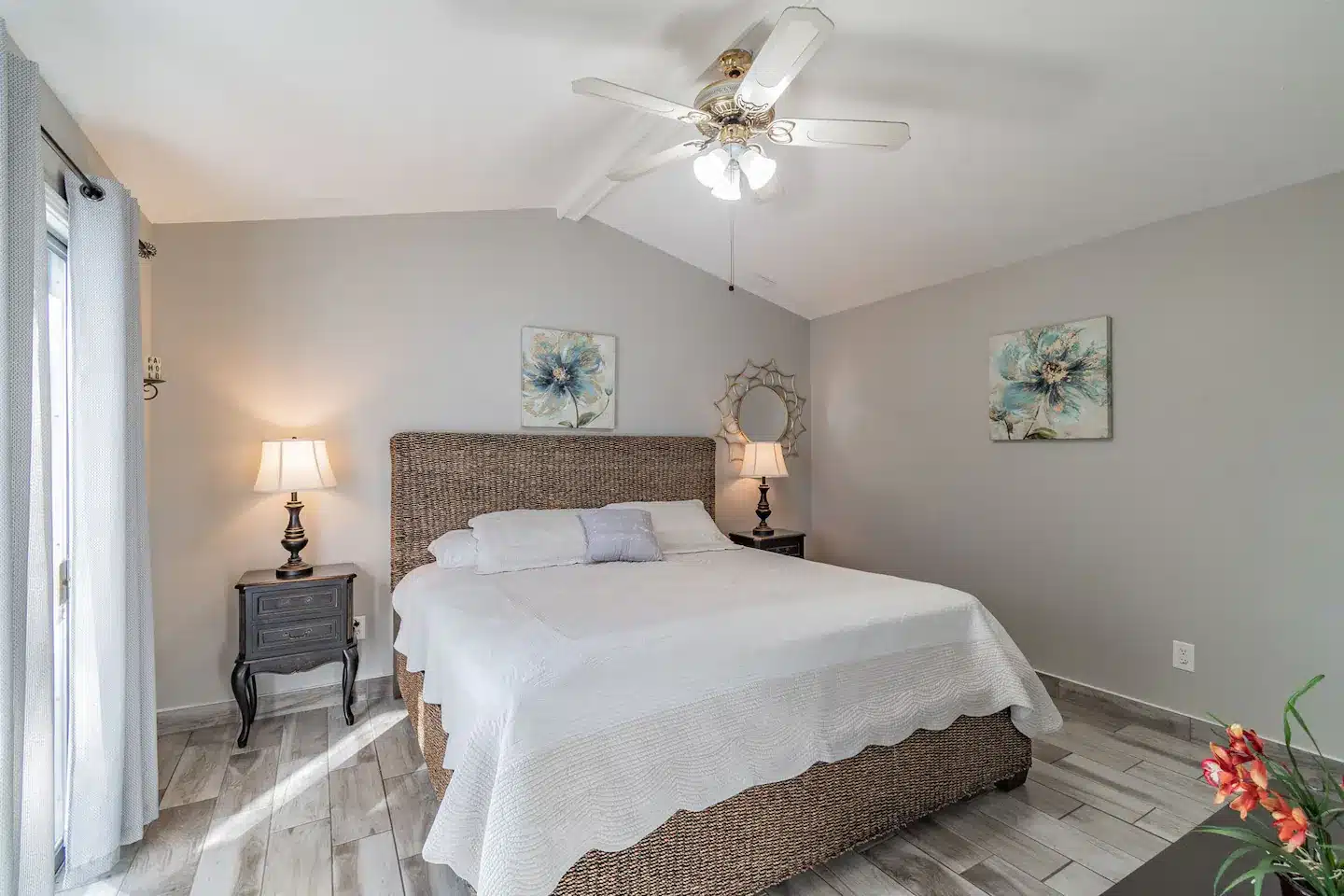 The master bedroom boasts a king-size bed and a sliding door that leads to the backyard oasis.