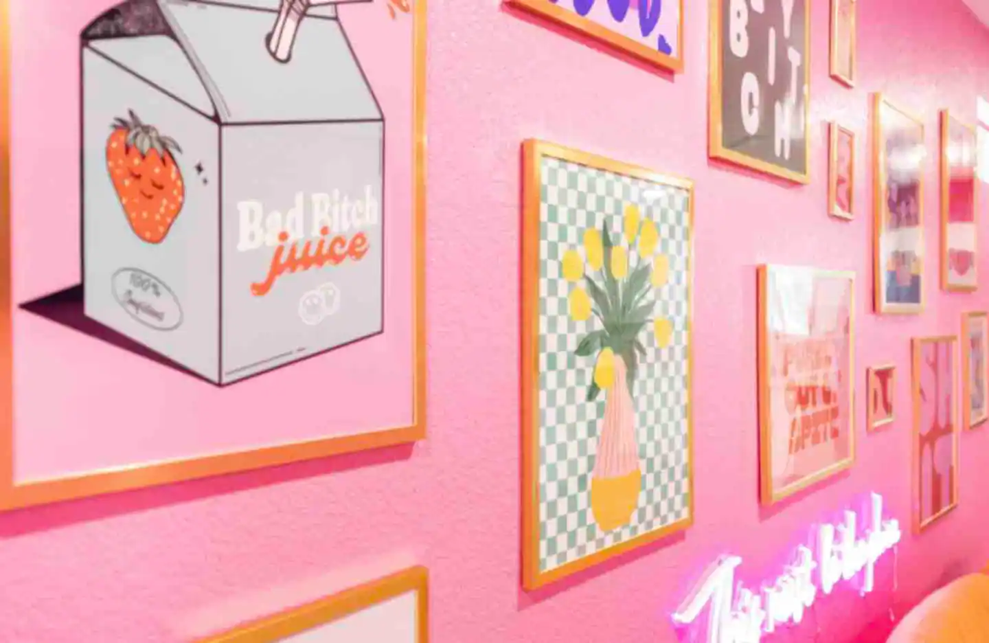 Gorgeous gallery wall of artwork and neon signs.