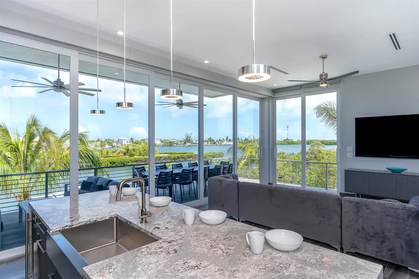 Modern kitchen and living space looks directly over the water