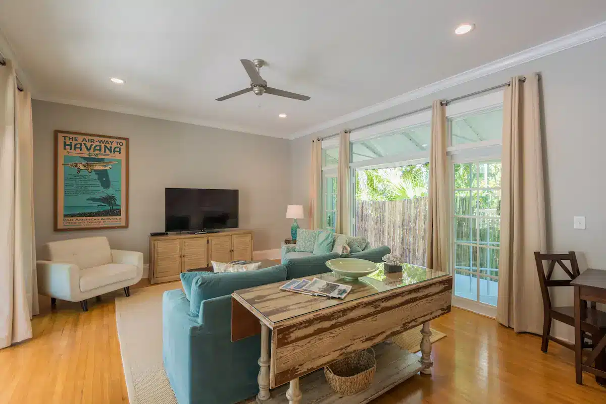 Bright airy and spacious living room with french doors on both sides leading to private patios.
